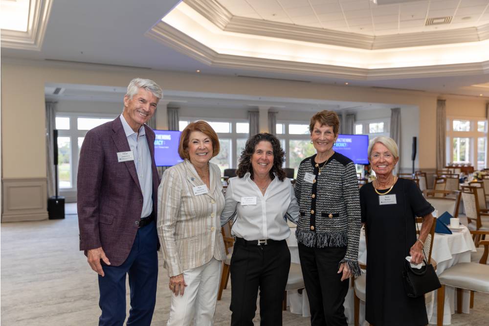 Mike and Sue Jandernoa, Stephanie Hurwitz, Margy Jones, and Jane Becker standing together posing for photo
